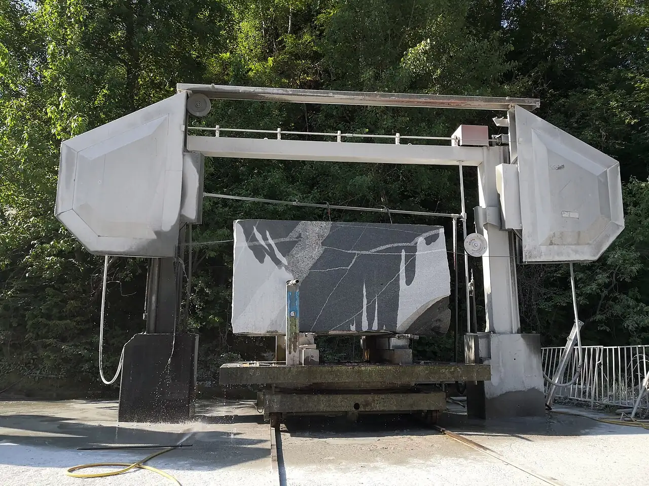 Multi-wire saw cutting a granite block